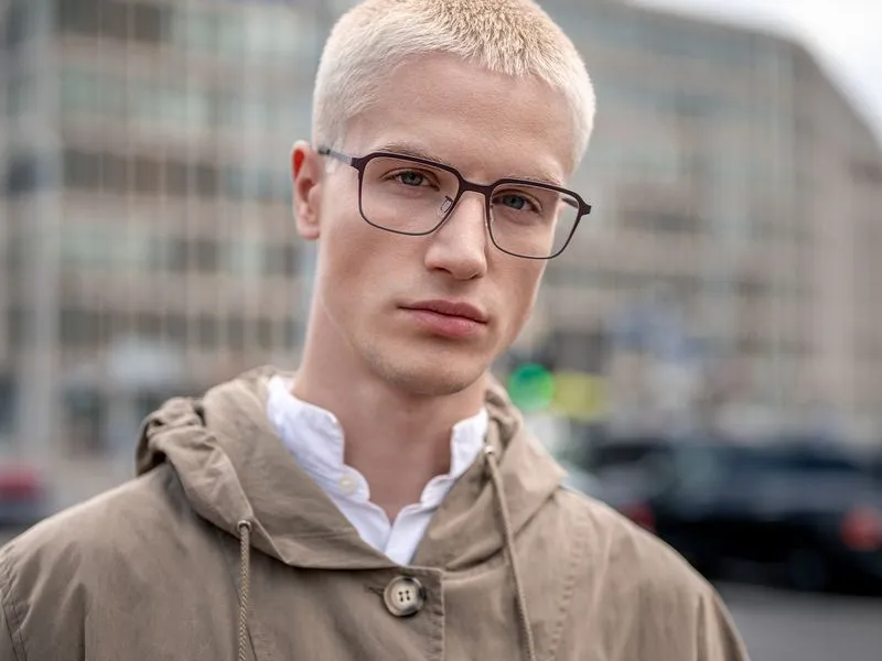 A man wearing slim titanium Blackfin spectacles