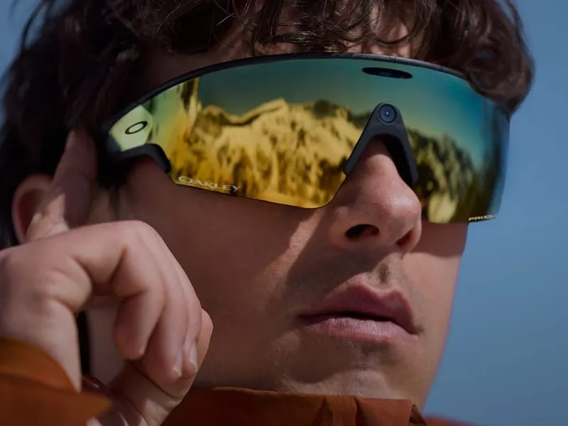 A close view of a man wearing Oakley Meta glasses with a yellow lens