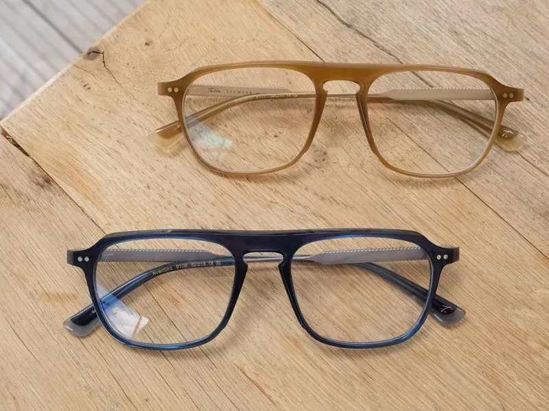 Two Talla acetate frames resting on a wooden surface