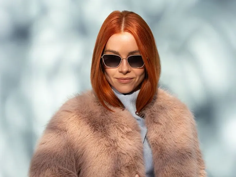 A woman in round Wolf sunglasses and a fur collar