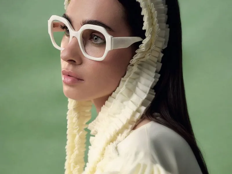 A woman wearing white angular Woodys frames