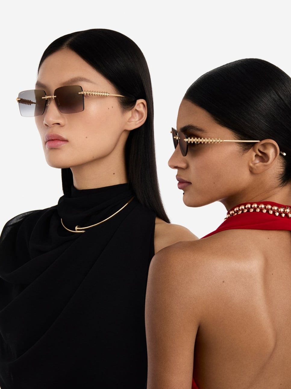 Two women wearing rimless Cartier sunglasses with gold temples