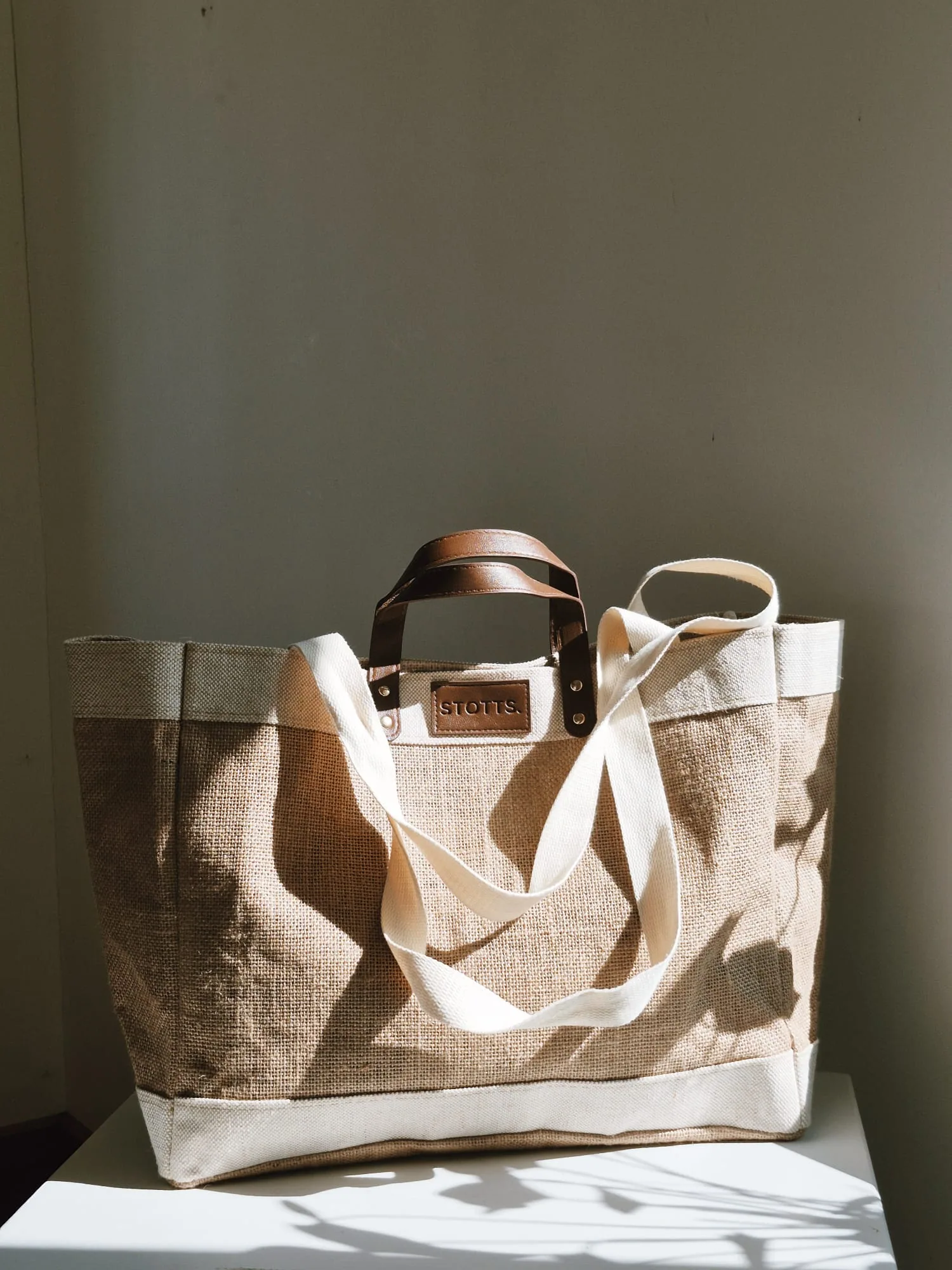 STOTTS. hessian and linen tote bag photographed in sunlight