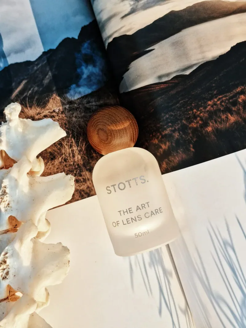 The lens cleaning spray bottle with its walnut cap