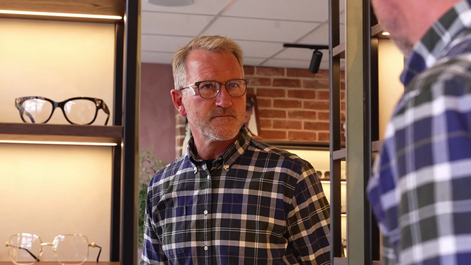 A client trying frames with guidance during a STOTTS. eyewear styling consultation