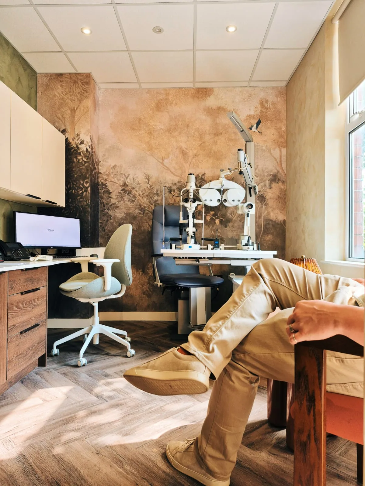 A calm, modern optician test room at STOTTS.